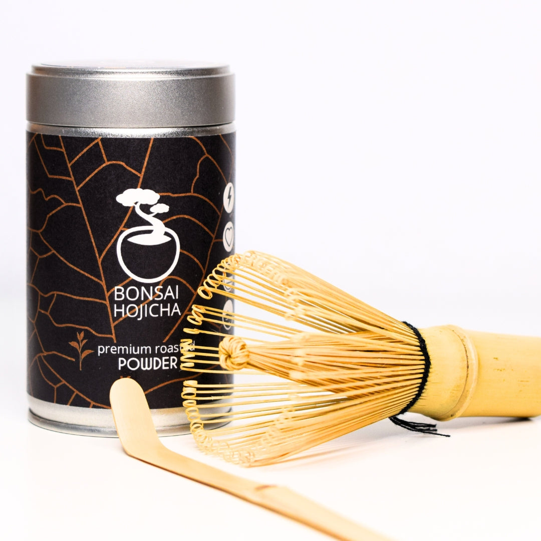 Bonsai Hojicha tea canister with a bamboo whisk on a white background