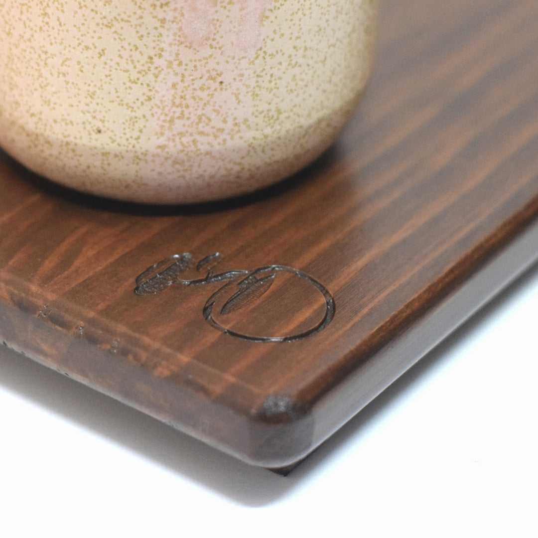 Close up of Bonsai Matcha logo engraved on handcrafted wooden tray with matcha chawan