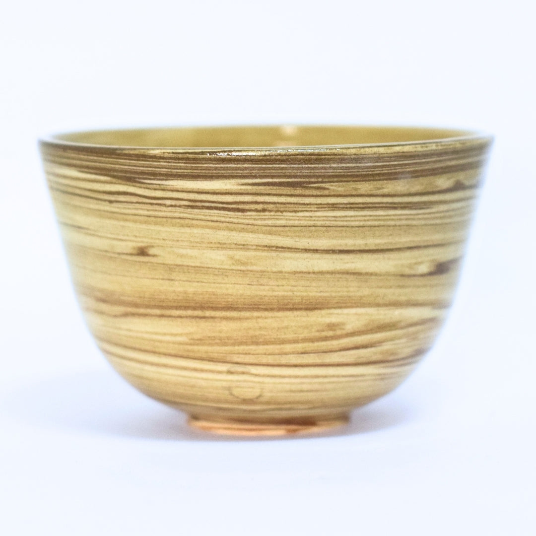 Handcrafted ceramic matcha bowl with gold glaze, Year of the Horse design, on white background